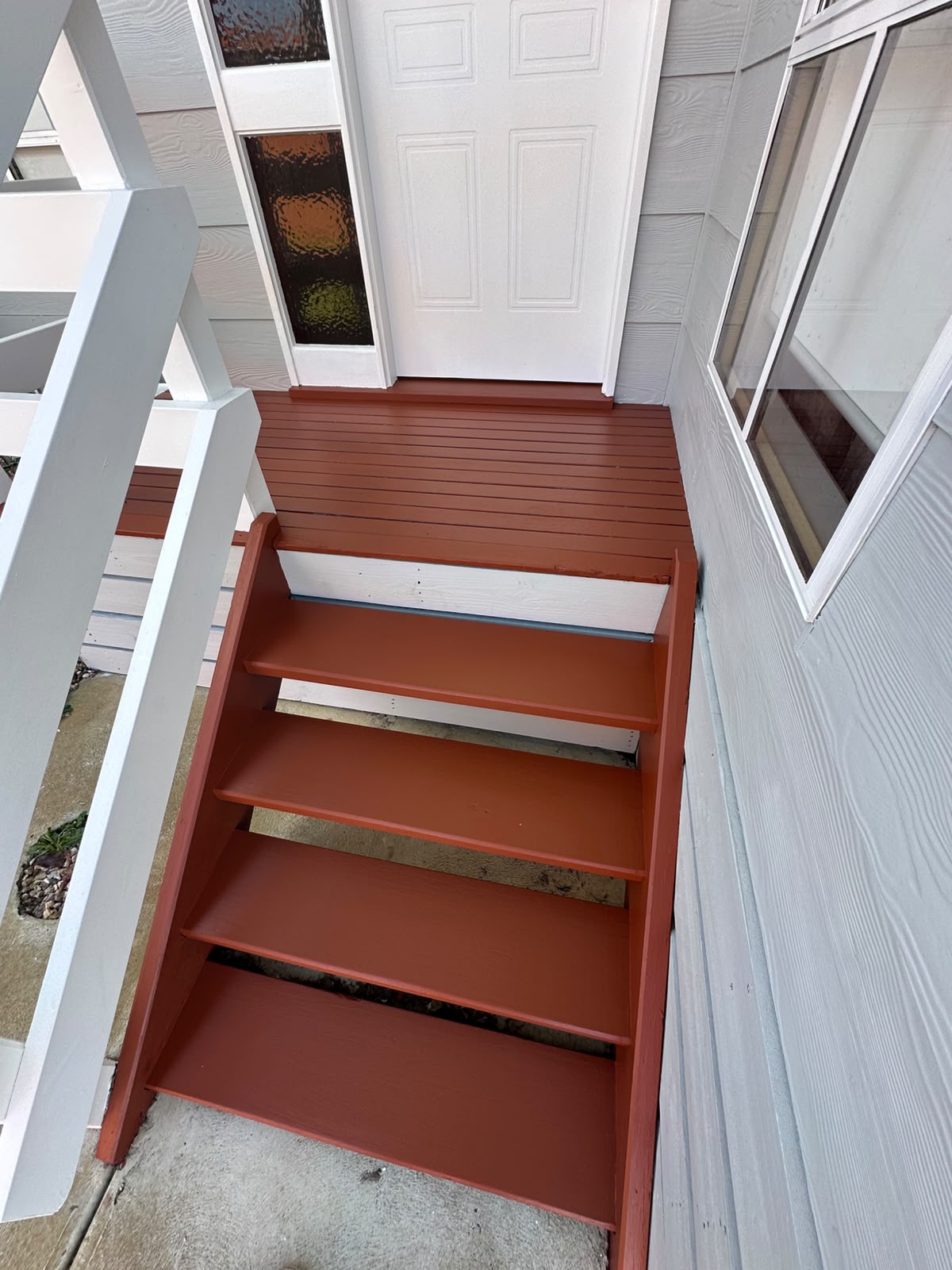 Weatherboard home porch and steps repainted in terracotta by ZN Painting Services
